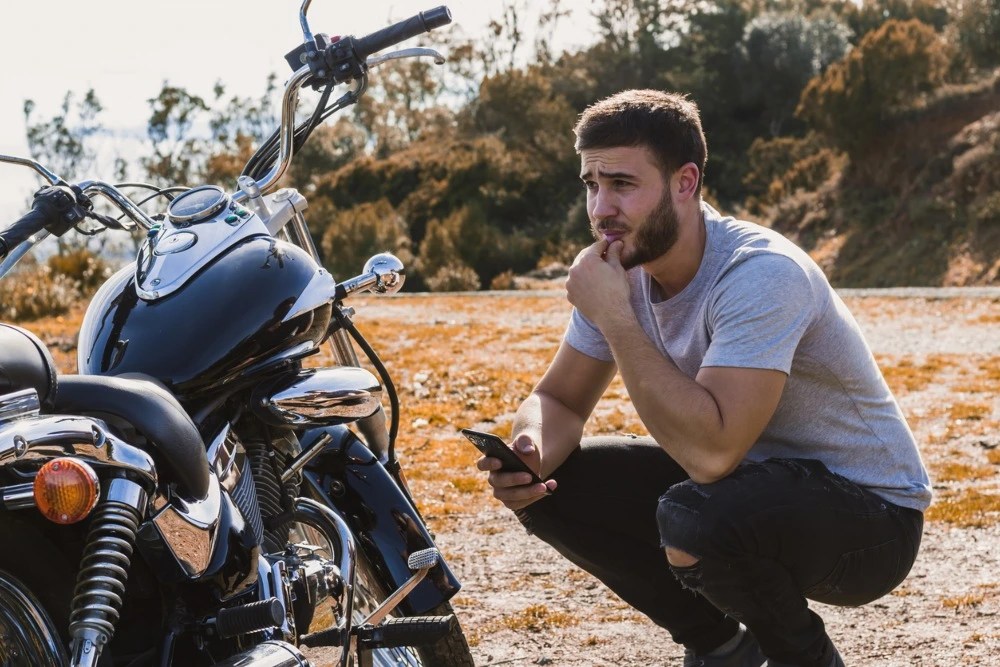 Hombre contactando a su seguro de moto.