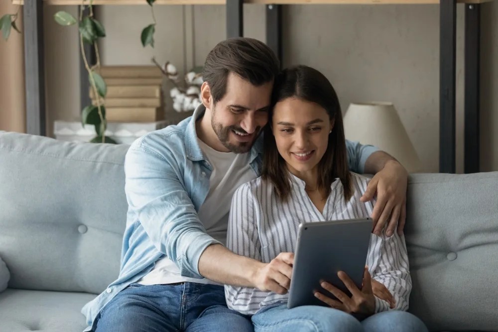 Pareja revisando en tablet el precio promedio de una casa en méxico.